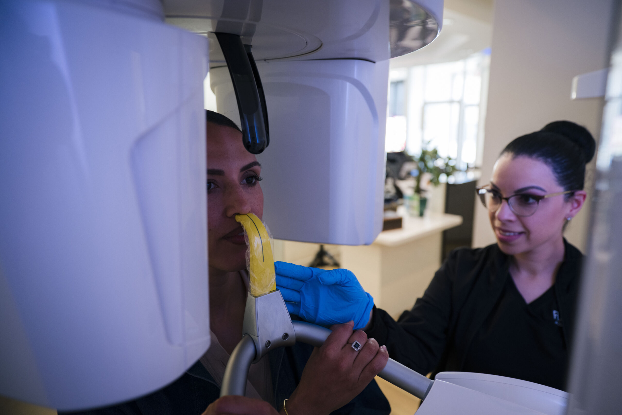 Dental professional holding 3D-printed model during patient consultation demonstration