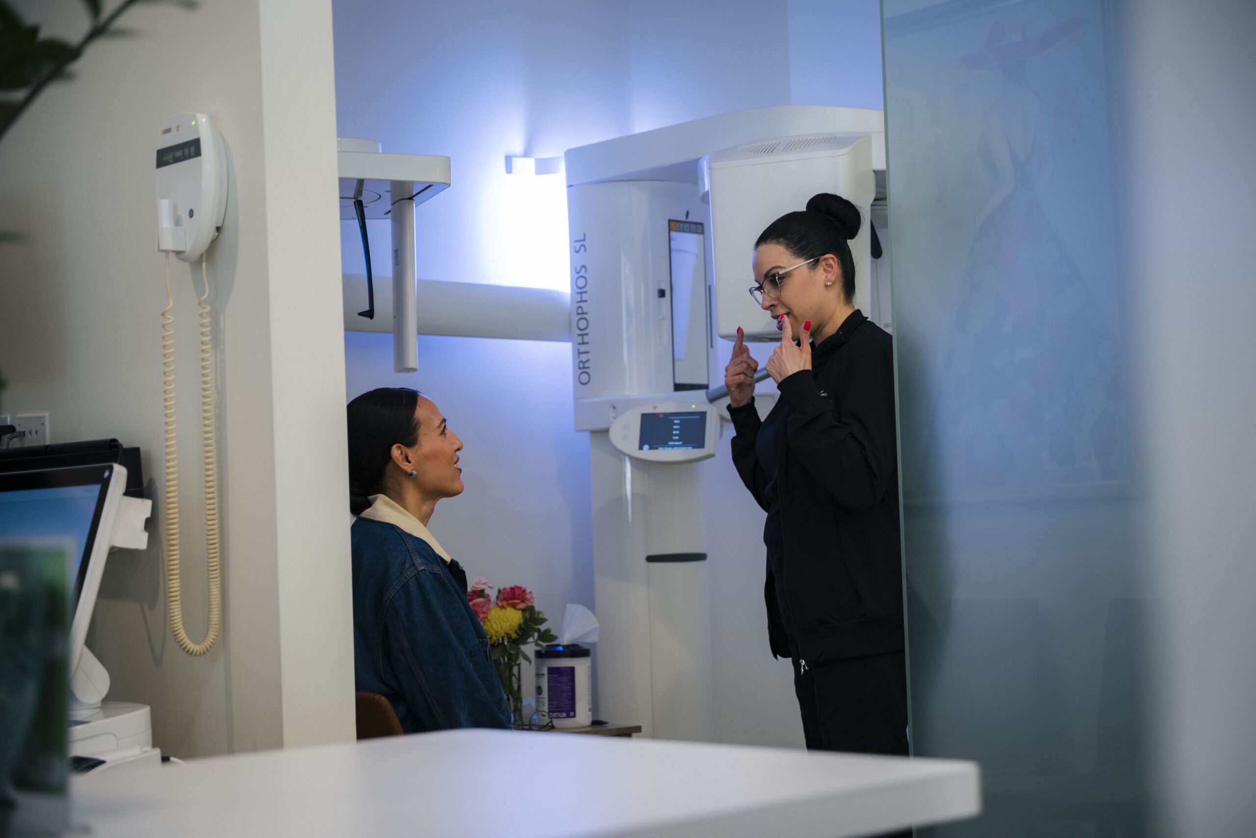 Dentist discussing treatment plan with patient in modern clinical setting