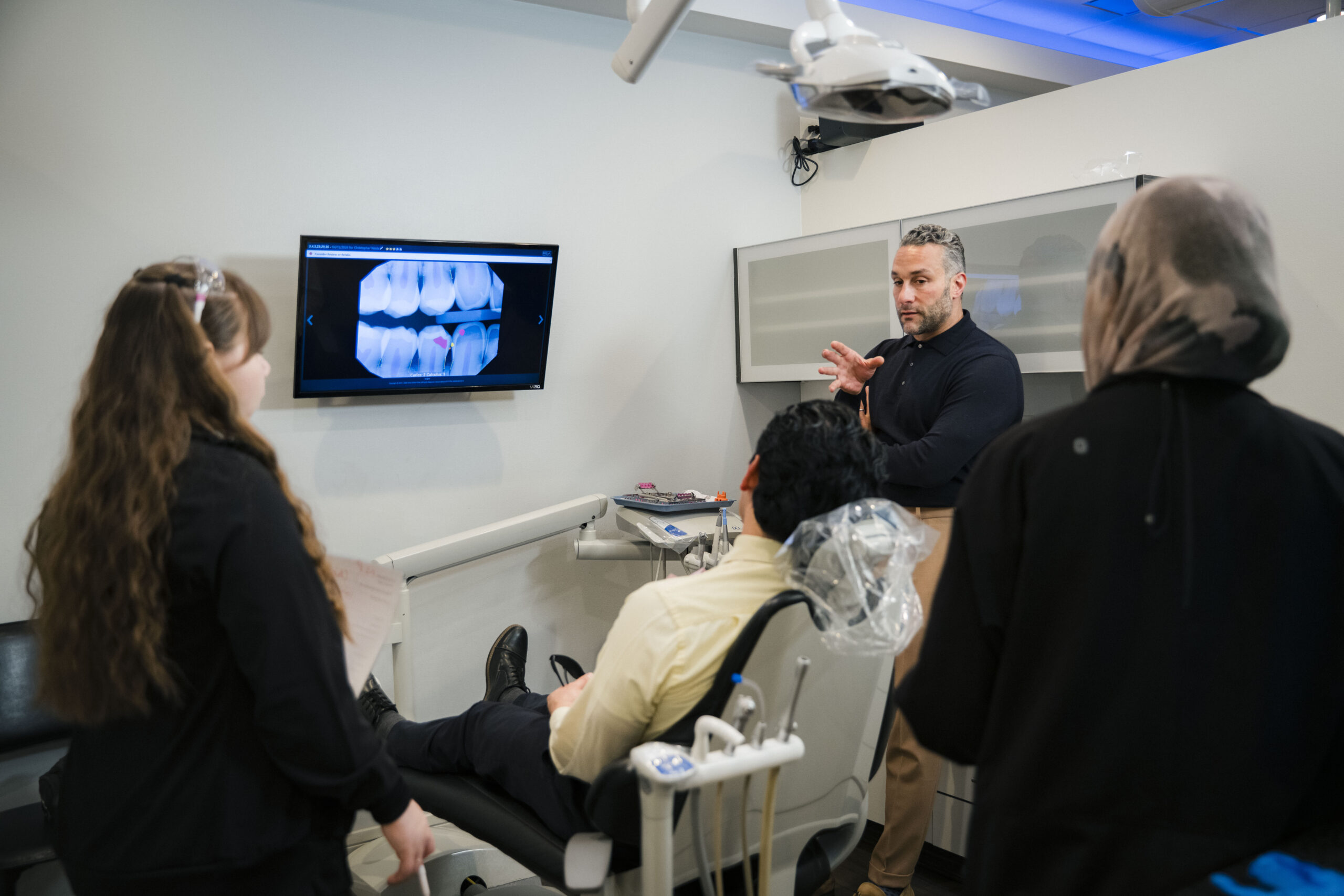 Dentist explaining dental X-rays to patient at The Holistic Airway Dentist